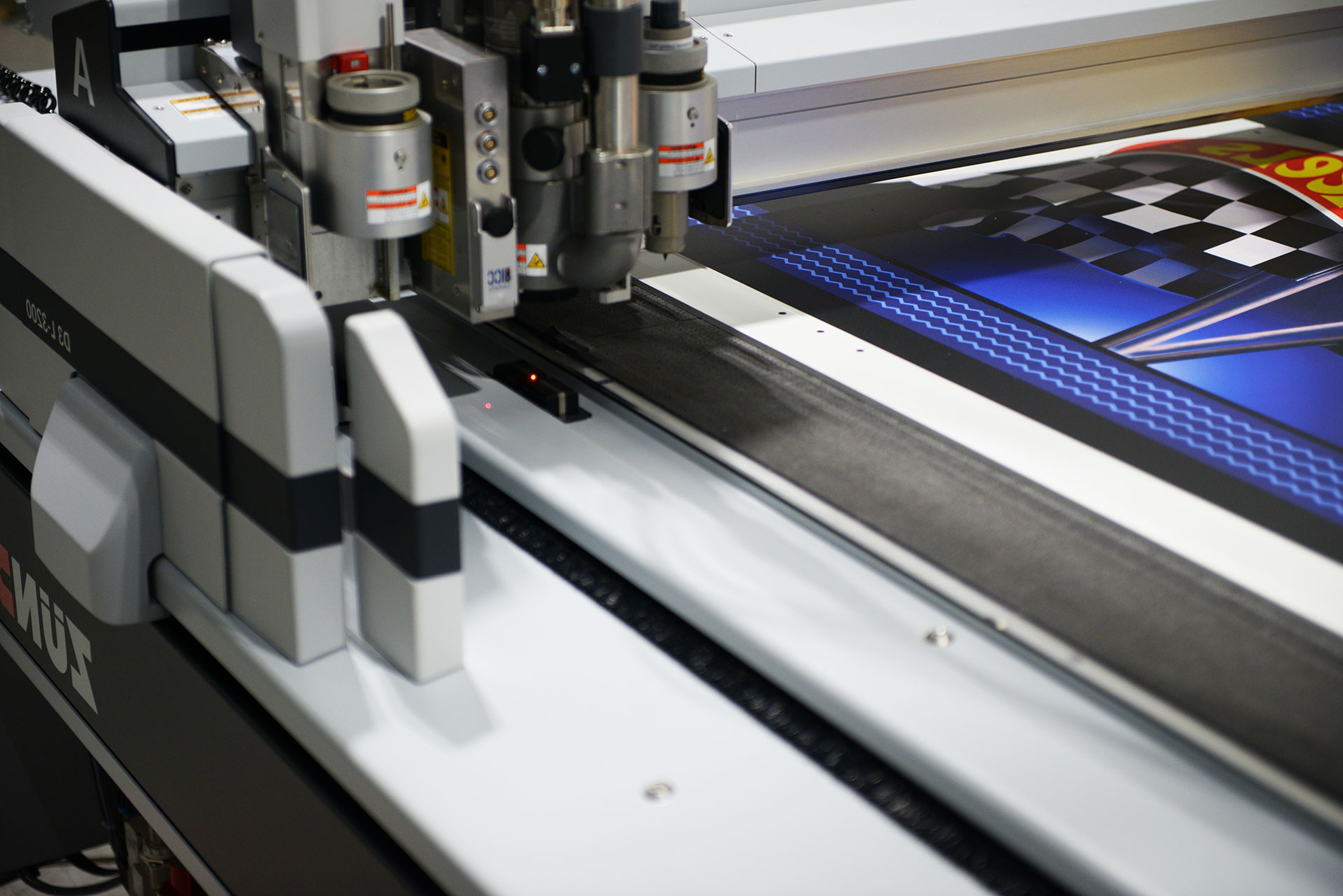 Detailed view of a Digitech UV flatbed print head applying high-resolution ink to a custom graphic.