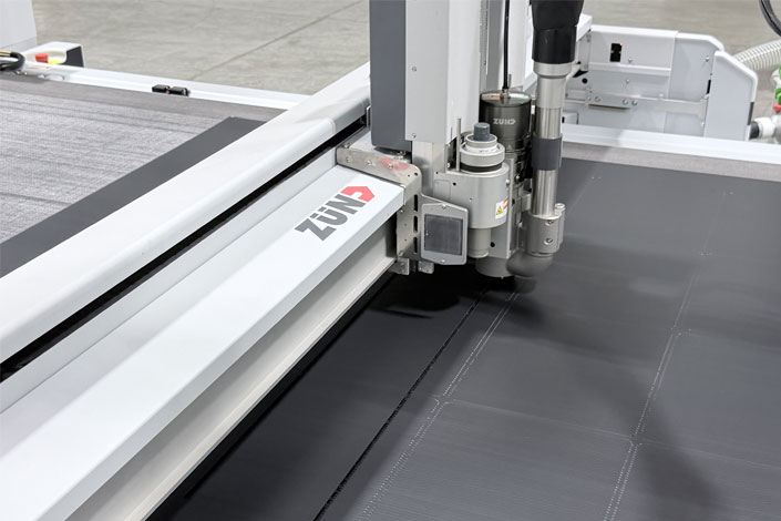 Precision Zünd digital die-cutting system at Infused Color Graphics, used for automated finishing of large-format printed graphics.